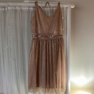Junior size 1. It was worn twice by me and once by a friend. Very sparkly!
